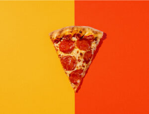 Slice of Pepperoni Pizza on an orange and yellow background at Holiday World & Splashin' Safari in Santa Claus, Indiana