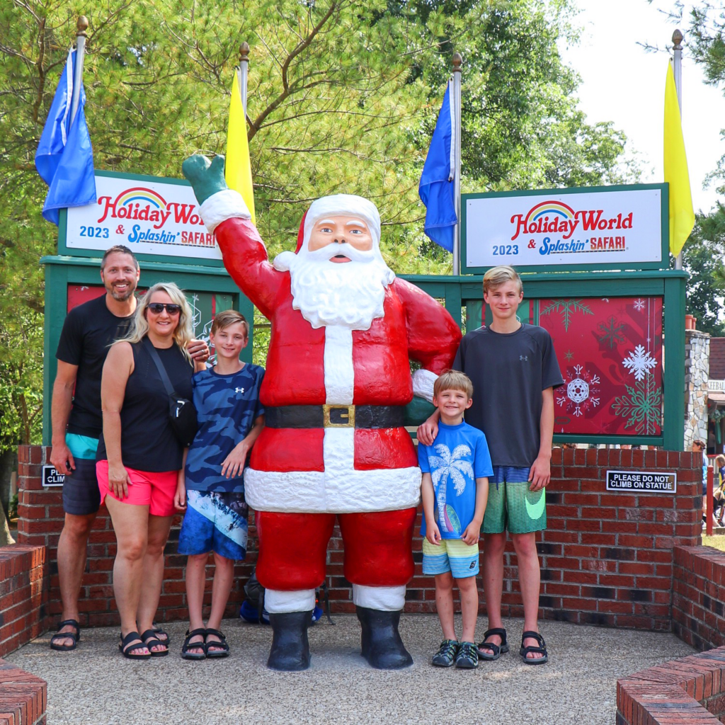 HoliBlogger Trina and her family by the Santa Statue.