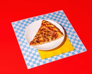 A slice of sausage pizza on a plate at Holiday World & Splashin' Safari in Santa Claus, Indiana.